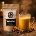 Central Texas Coffee Co. loose leaf flavored tea package with a steaming mug of masala chai on a wooden surface.